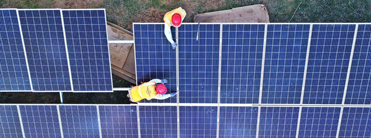 Men working on solar panels