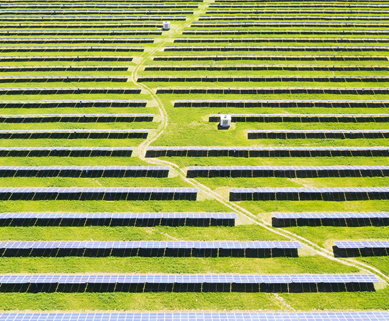 Solar power plant seen from above in green field