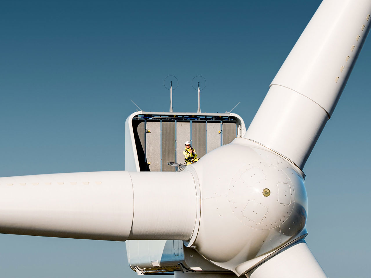 Top of a wind turbine with a Statkraft employee in the top for inspections