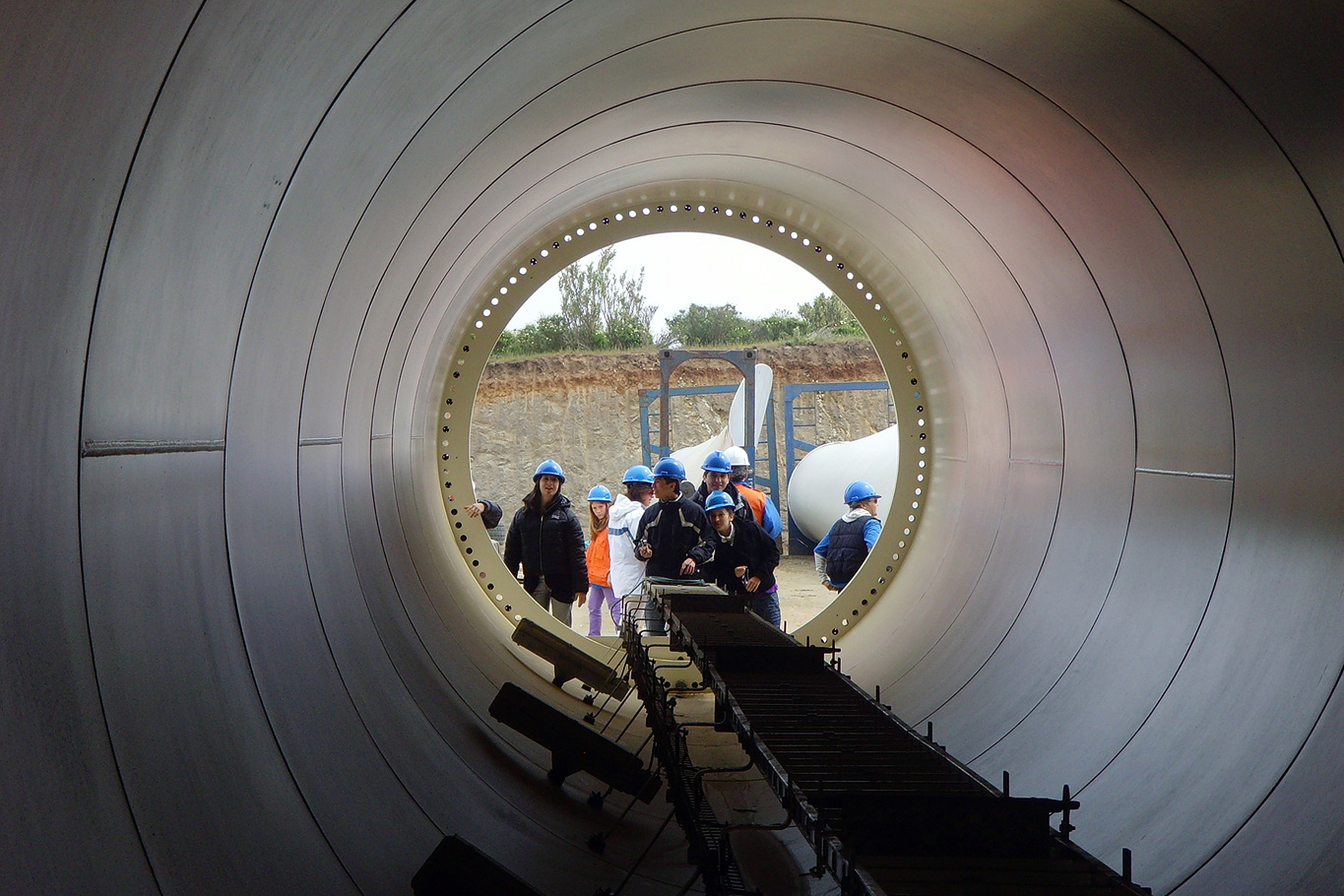 People looking into a big pipeline element