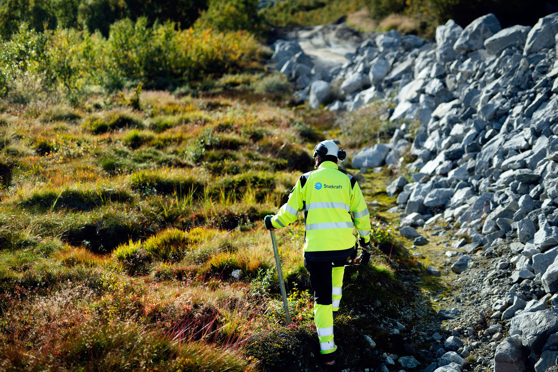 Man walking on patches of peatPatch of soil with plants