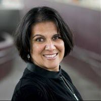 Female with dark hair smiling