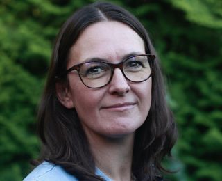 Female with brown hair and glasses
