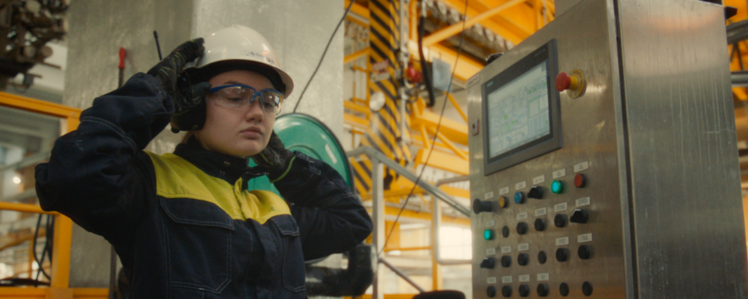 Lady in protective gear inside a production facility
