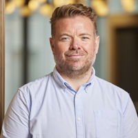 Man in blue shirt smiling to the camera