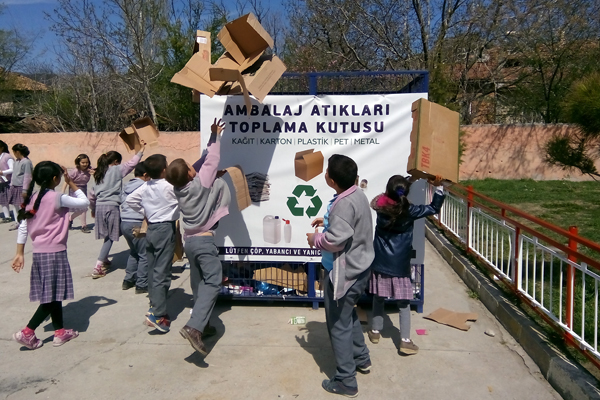 Children throwing waste in bin